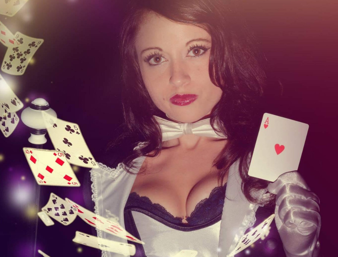 a girl does magic tricks with cards a magician with cards